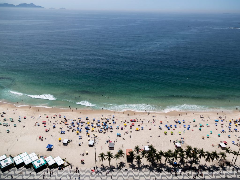 An aerial shot of Copacabana beach in Rio de Janeiro Brazil crowded with people